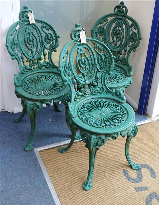 A set of three Coalbrookdale green painted cast iron garden chairs